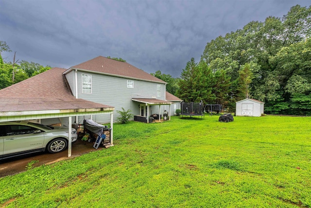  - view of green lawn featuring a storage shed and a trampoline