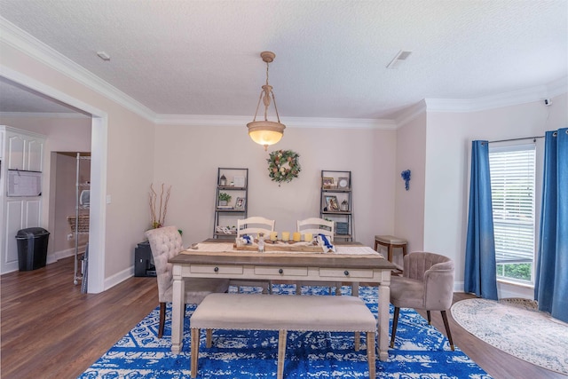  - dining room featuring wood finished floors, ornamental molding, and a textured ceiling