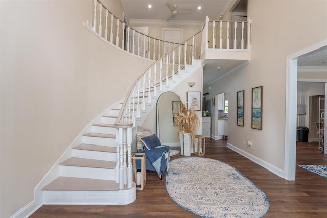  - stairway featuring crown molding, wood finished floors, a towering ceiling, a ceiling fan, and recessed lighting