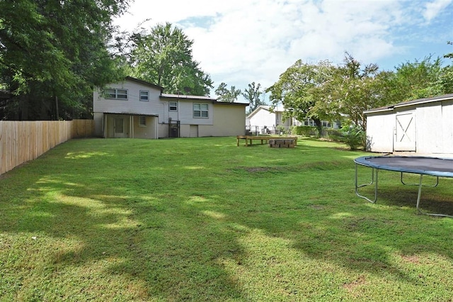 view of yard with a storage unit and a trampoline