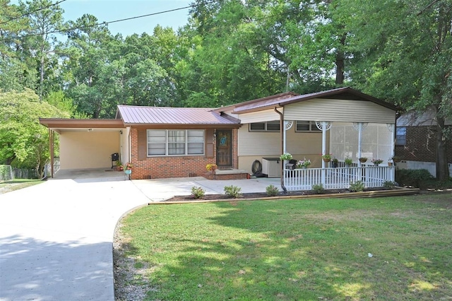 - view of front of home with a carport and a front lawn