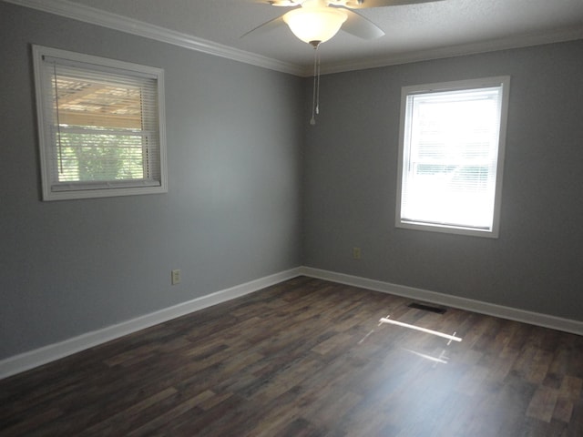 empty room with dark hardwood / wood-style floors, ceiling fan, and ornamental molding