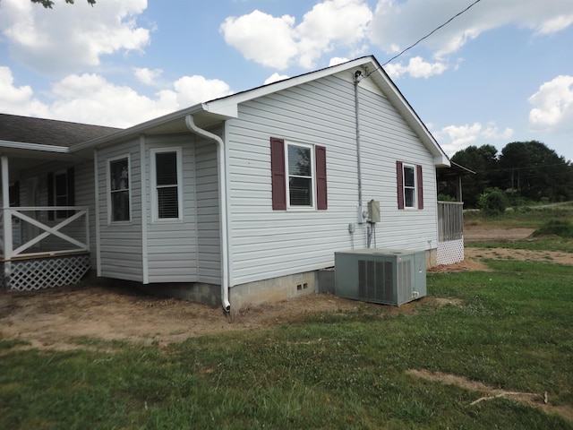 view of property exterior featuring a lawn and cooling unit