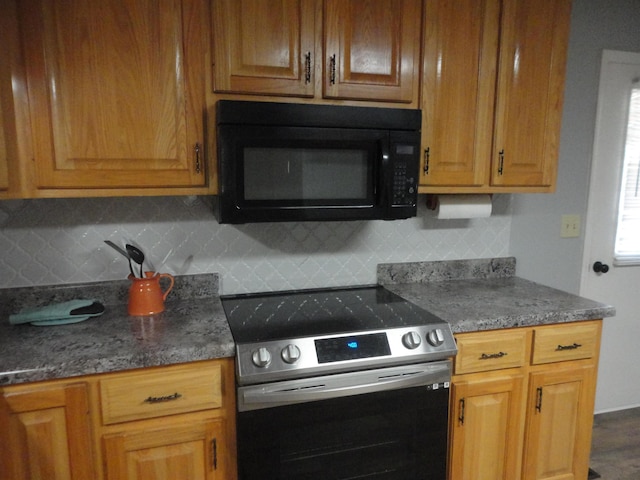 kitchen featuring stainless steel electric range oven and tasteful backsplash