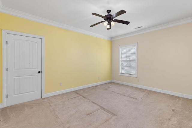 empty room with ceiling fan, light colored carpet, and ornamental molding