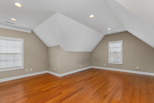 bonus room with vaulted ceiling and hardwood / wood-style flooring