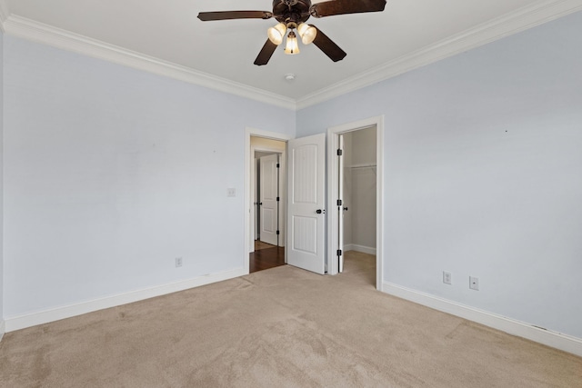 carpeted spare room featuring ceiling fan and ornamental molding