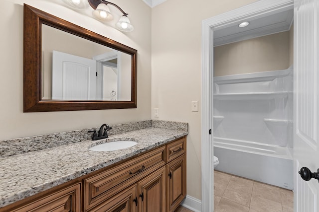 bathroom featuring tile patterned floors, toilet, vanity, and ornamental molding