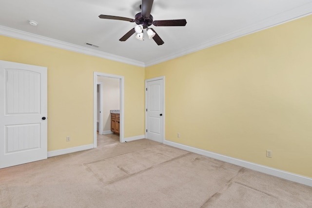 unfurnished bedroom with carpet, ceiling fan, ornamental molding, and ensuite bathroom