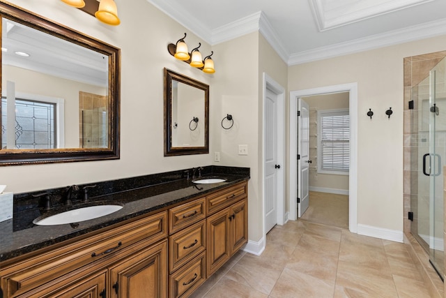 bathroom with a healthy amount of sunlight, vanity, a shower with shower door, and ornamental molding