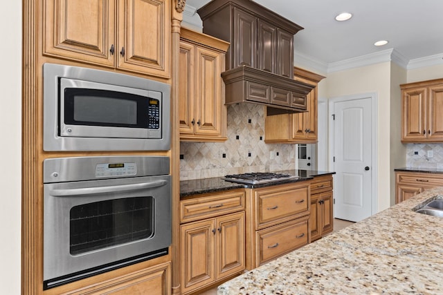 kitchen featuring appliances with stainless steel finishes, backsplash, light stone counters, and ornamental molding