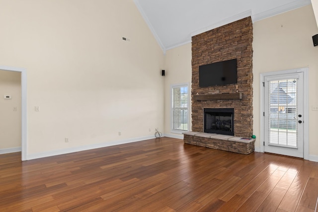 unfurnished living room with a fireplace, dark hardwood / wood-style flooring, high vaulted ceiling, and ornamental molding