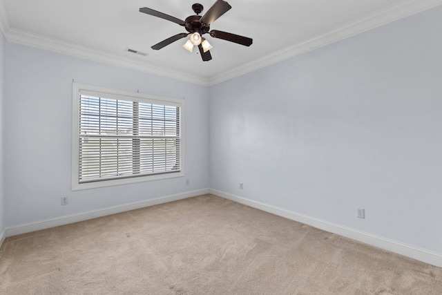 carpeted empty room featuring ceiling fan and crown molding