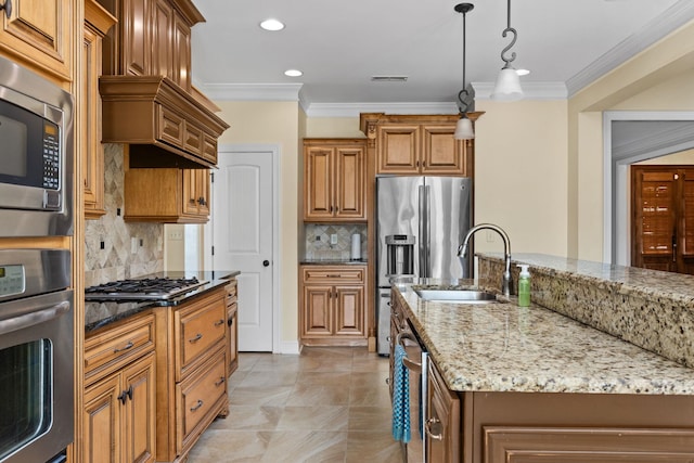 kitchen featuring stainless steel appliances, light stone counters, backsplash, a kitchen island with sink, and ornamental molding