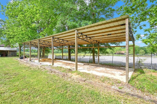 view of parking featuring a detached carport and fence