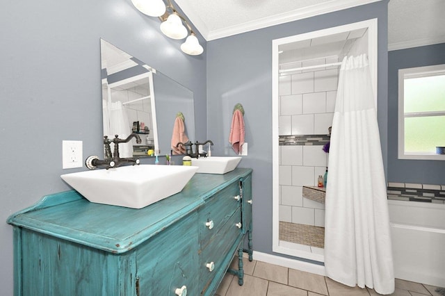 bathroom with ornamental molding, a sink, and tiled shower
