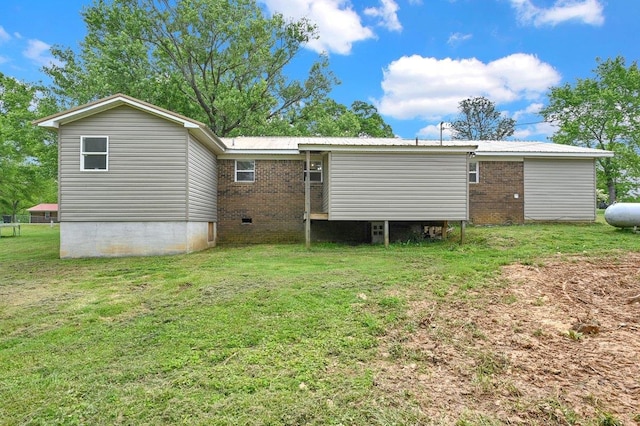 back of house with a lawn, crawl space, and brick siding