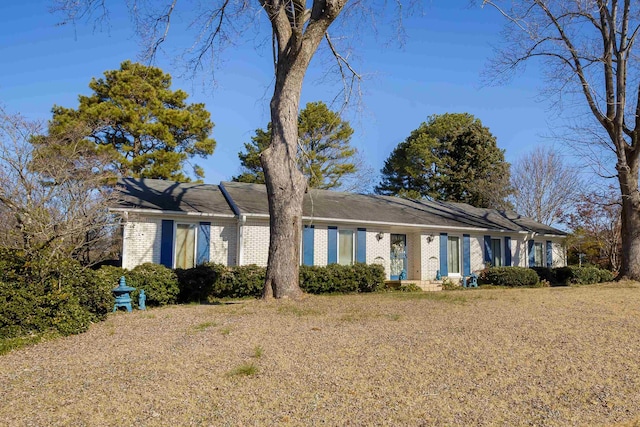 ranch-style house with a front lawn