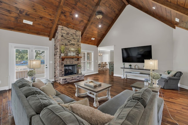 living area featuring a chandelier, wood ceiling, wood-type flooring, a fireplace, and high vaulted ceiling