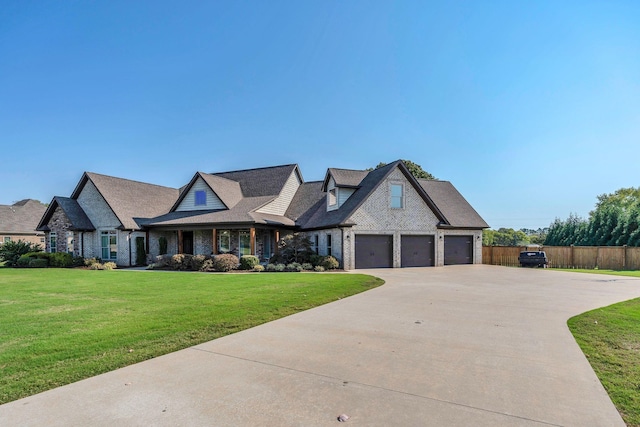 view of front facade featuring a garage, brick siding, fence, concrete driveway, and a front yard