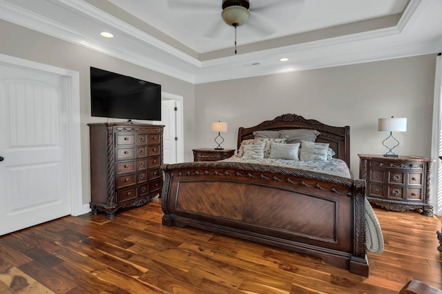 bedroom with ceiling fan, ornamental molding, dark wood-type flooring, a tray ceiling, and recessed lighting