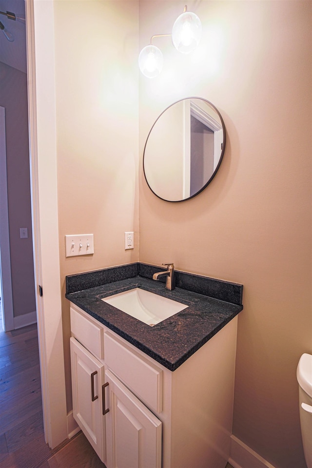 bathroom featuring vanity, toilet, and wood-type flooring