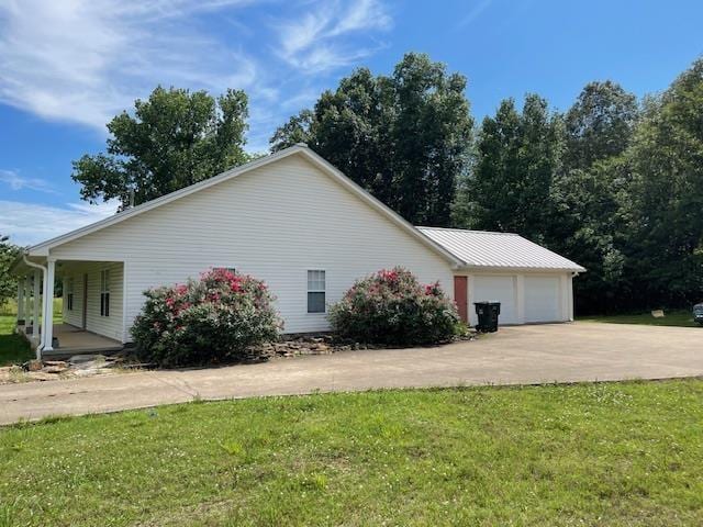  - view of property exterior featuring a yard and covered porch