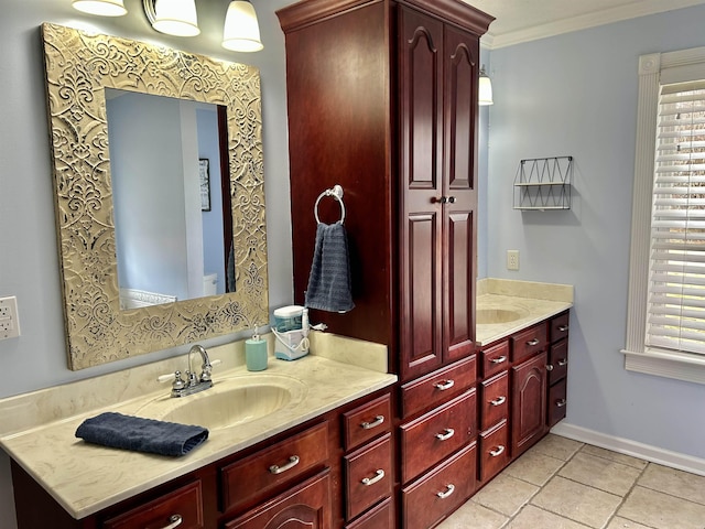 bathroom with crown molding, vanity, and baseboards