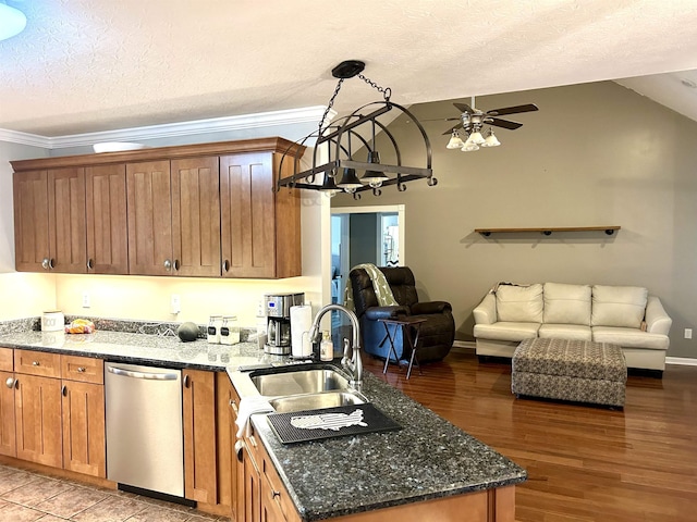 kitchen with a peninsula, a sink, open floor plan, vaulted ceiling, and stainless steel dishwasher