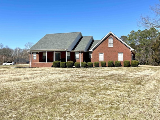 view of front of house featuring a shingled roof and brick siding