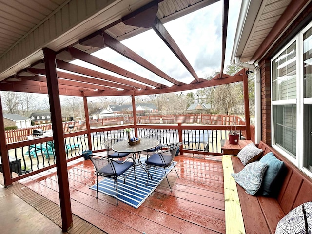 deck with a fenced backyard and outdoor dining space