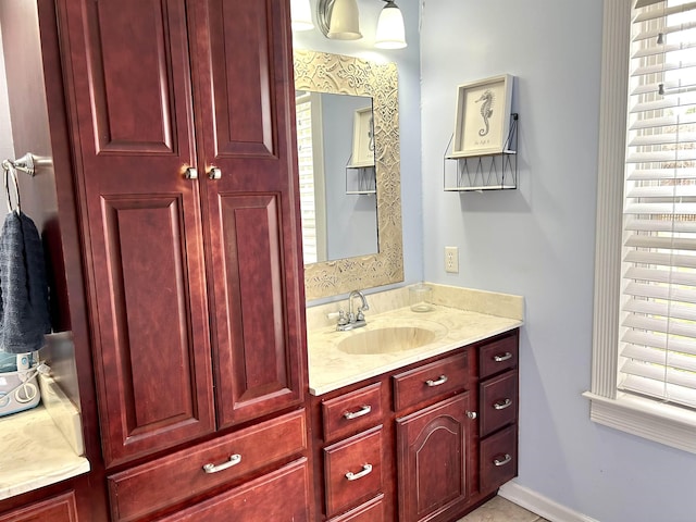 bathroom with vanity and baseboards