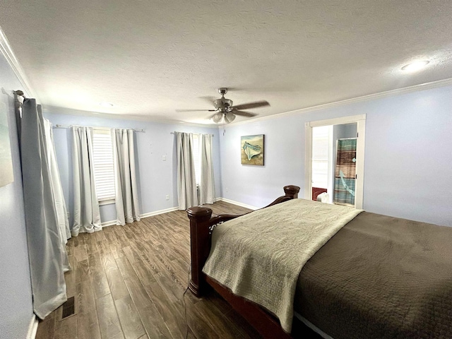 bedroom with a textured ceiling, wood finished floors, visible vents, a ceiling fan, and ornamental molding