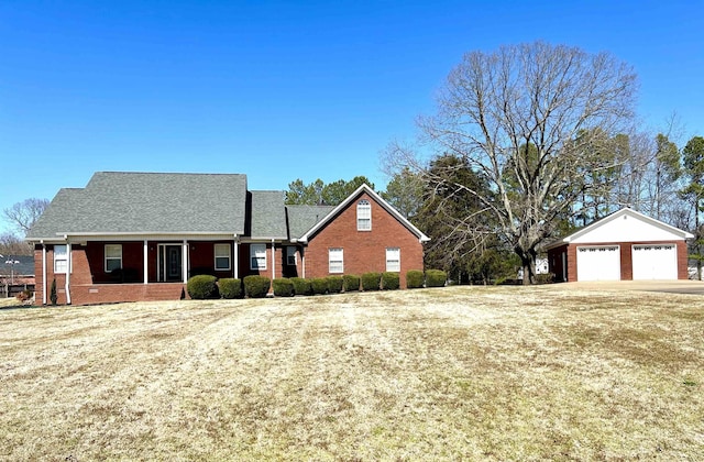 view of front of house featuring an outbuilding and brick siding