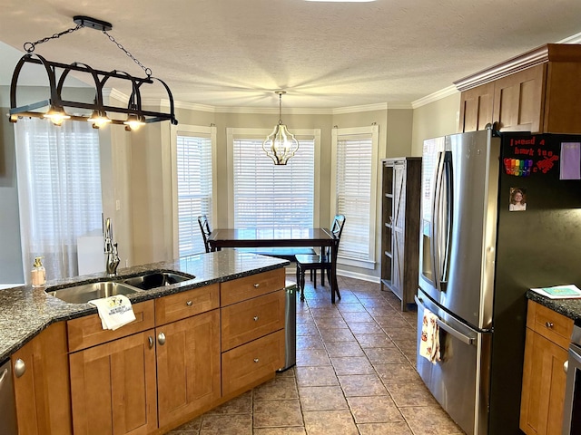 kitchen with ornamental molding, brown cabinets, an inviting chandelier, stainless steel refrigerator with ice dispenser, and a sink