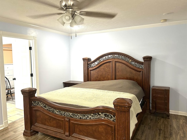 bedroom with baseboards, ceiling fan, wood finished floors, crown molding, and a textured ceiling