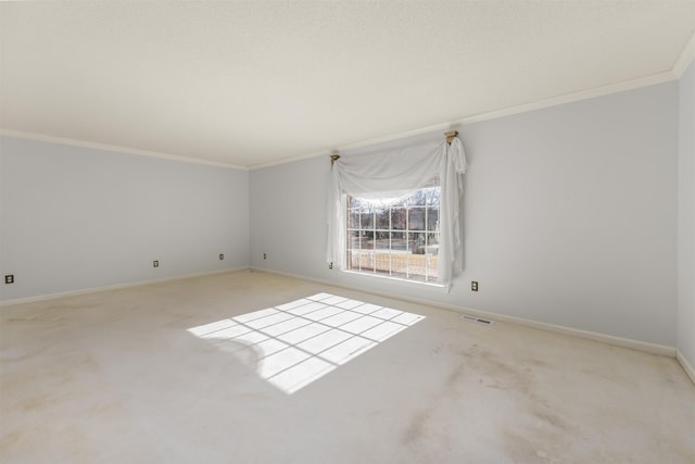 spare room with light colored carpet and ornamental molding