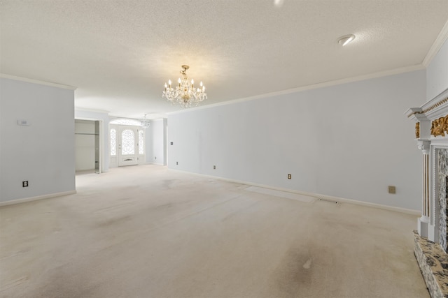 unfurnished living room featuring light carpet, a fireplace, an inviting chandelier, and ornamental molding