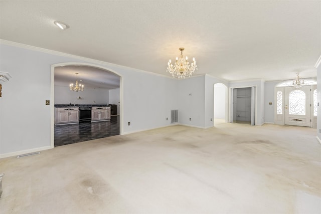 unfurnished living room featuring crown molding, sink, and carpet