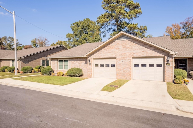 single story home featuring a front lawn and a garage