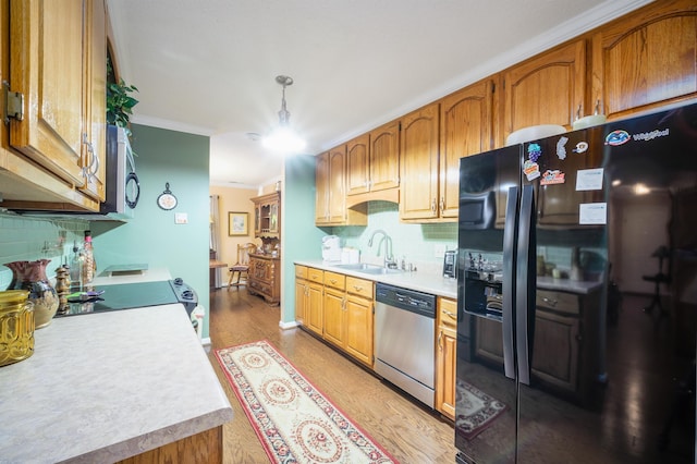 kitchen with dishwasher, sink, light hardwood / wood-style flooring, black fridge with ice dispenser, and ornamental molding