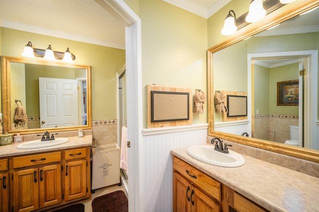 bathroom featuring vanity, toilet, and crown molding