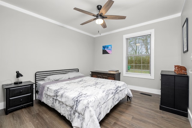 bedroom with ceiling fan, dark hardwood / wood-style flooring, and crown molding