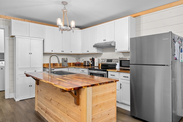 kitchen featuring wood counters, appliances with stainless steel finishes, sink, white cabinetry, and hanging light fixtures