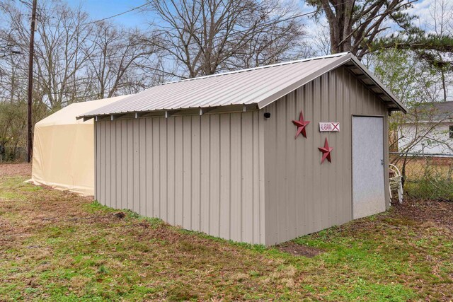 view of outbuilding with a lawn