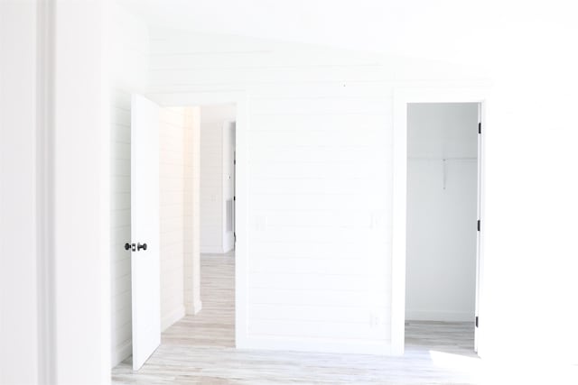  - hallway with light wood-style flooring