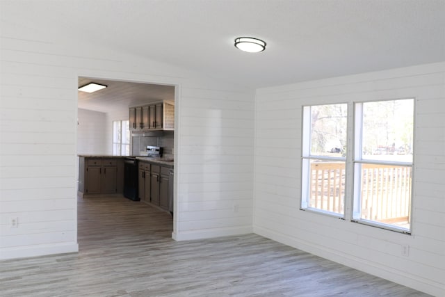  - unfurnished dining area featuring light wood-style flooring, healthy amount of natural light, and baseboards