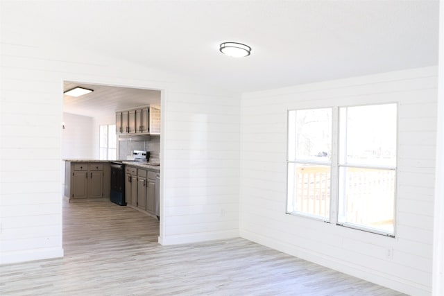  - unfurnished dining area featuring light wood-type flooring and baseboards