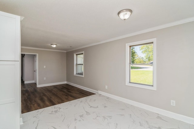 unfurnished room with crown molding