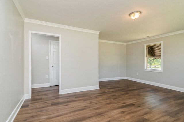 empty room with crown molding and dark wood-type flooring